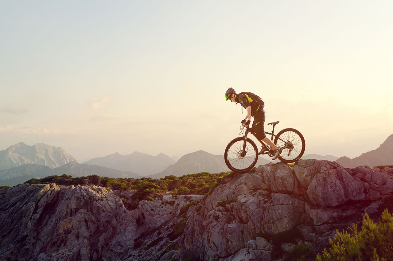 cyclist overcomes mountains